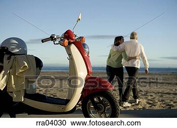 Stock Photography - senior couple 
walking away from 
moped. fotosearch 
- search stock 
photos, pictures, 
images, and photo 
clipart
