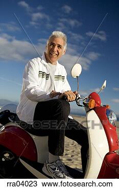 Stock Photo - senior man riding 
moped. fotosearch 
- search stock 
photos, pictures, 
images, and photo 
clipart