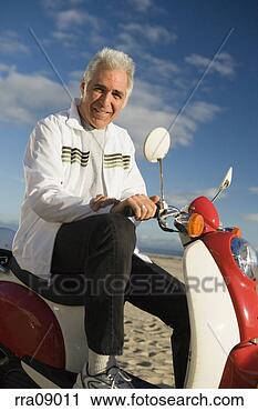 Stock Photography - senior man riding 
scooter. fotosearch 
- search stock 
photos, pictures, 
images, and photo 
clipart