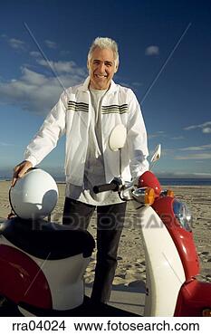 Stock Photo - senior man standing 
by moped. fotosearch 
- search stock 
photos, pictures, 
images, and photo 
clipart
