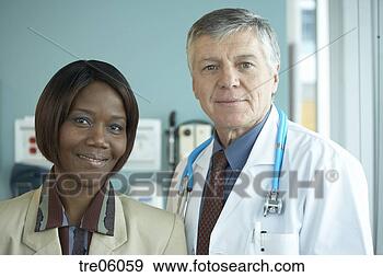Stock Photograph - smiling healthcare 
worker and doctor. 
fotosearch - search 
stock photos, 
pictures, images, 
and photo clipart