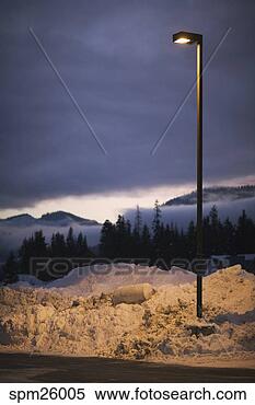 Stock Image - street light in 
snow bank by parking 
lot. fotosearch 
- search stock 
photos, pictures, 
images, and photo 
clipart