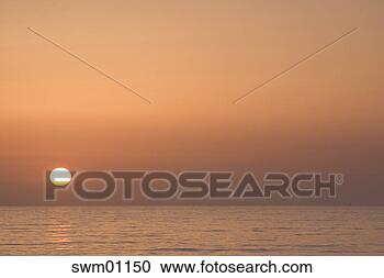Stock Photography - sun setting over 
water. fotosearch 
- search stock 
photos, pictures, 
images, and photo 
clipart