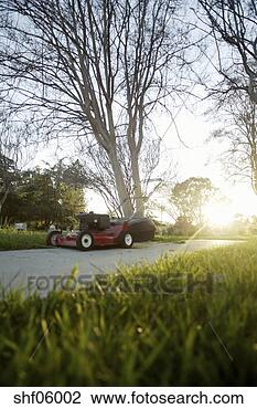 Stock Photo - surface level 
view of lawn mower 
next to house. 
fotosearch - search 
stock photos, 
pictures, images, 
and photo clipart