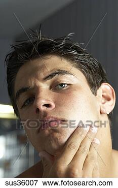 Picture - teenage boy admiring 
self in mirror. 
fotosearch - search 
stock photos, 
pictures, images, 
and photo clipart