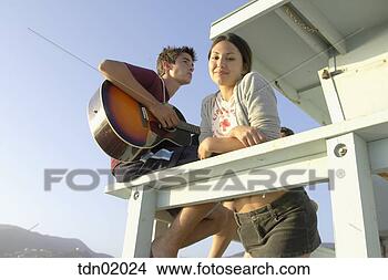 Stock Photo - teenage couple 
standing on lifeguard 
hut. fotosearch 
- search stock 
photos, pictures, 
images, and photo 
clipart