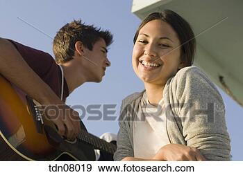 Stock Photograph - teenage couple 
standing on lifeguard 
hut. fotosearch 
- search stock 
photos, pictures, 
images, and photo 
clipart