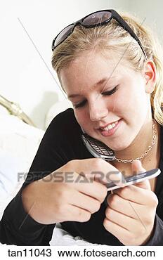 Stock Photo - teenage girl filing 
her fingernails 
while on phone. 
fotosearch - search 
stock photos, 
pictures, images, 
and photo clipart
