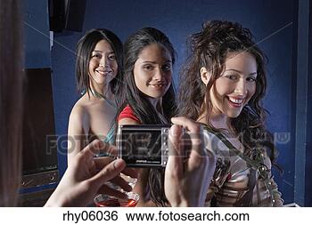 Stock Photo - three young women 
having their photograph 
taken. fotosearch 
- search stock 
photos, pictures, 
images, and photo 
clipart