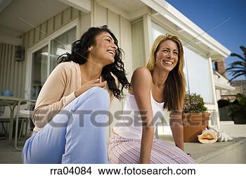 Stock Photo - two women laughing 
outdoors. fotosearch 
- search stock 
photos, pictures, 
images, and photo 
clipart