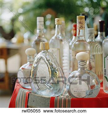 Stock Image - variety of bottles 
of alcohol on 
side table. fotosearch 
- search stock 
photos, pictures, 
images, and photo 
clipart