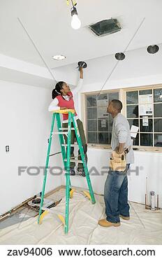 Stock Photo - woman changing 
a lightbulb. fotosearch 
- search stock 
photos, pictures, 
images, and photo 
clipart