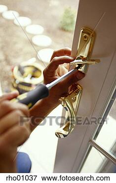 Picture - woman changing 
a lock. fotosearch 
- search stock 
photos, pictures, 
images, and photo 
clipart