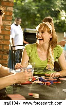 Picture - woman gambling 
at outdoor table. 
fotosearch - search 
stock photos, 
pictures, images, 
and photo clipart