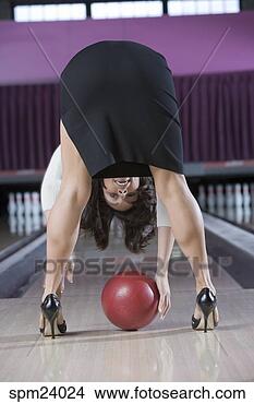 Stock Photo - woman in high 
heels bending 
over picking up 
a bowling ball. 
fotosearch - search 
stock photos, 
pictures, images, 
and photo clipart