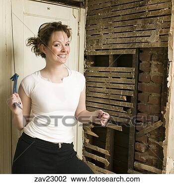 Stock Photo - woman holding 
crowbar. fotosearch 
- search stock 
photos, pictures, 
images, and photo 
clipart