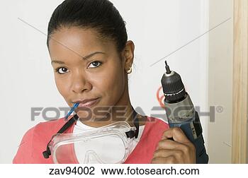 Stock Photo - woman holding 
a power drill. 
fotosearch - search 
stock photos, 
pictures, images, 
and photo clipart