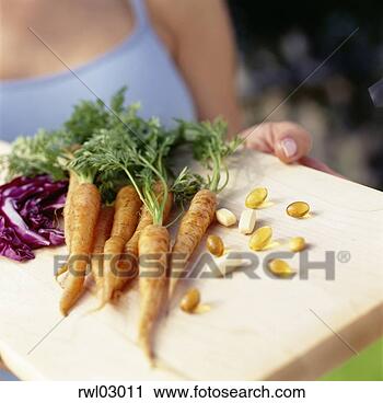 Stock Photography - woman holding 
tray of vegetables 
and vitamins. 
fotosearch - search 
stock photos, 
pictures, images, 
and photo clipart