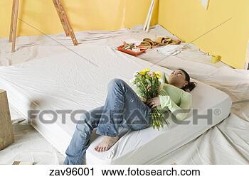 Stock Photography - woman laying on 
mattress in unfinished 
room. fotosearch 
- search stock 
photos, pictures, 
images, and photo 
clipart
