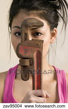 Stock Photo - woman looking 
through monkey 
wrench. fotosearch 
- search stock 
photos, pictures, 
images, and photo 
clipart