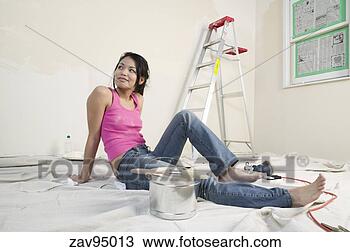 Stock Photo - woman resting 
in unfinished 
room. fotosearch 
- search stock 
photos, pictures, 
images, and photo 
clipart