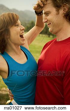 Picture - woman ruffling 
boyfriend's hair. 
fotosearch - search 
stock photos, 
pictures, images, 
and photo clipart