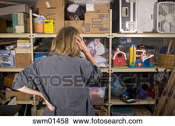 Stock Photo - woman searching 
through full shelves. 
fotosearch - search 
stock photos, 
pictures, images, 
and photo clipart