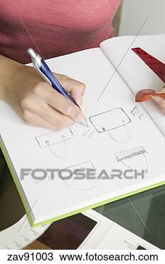 Stock Photo - woman sketching 
out purse designs. 
fotosearch - search 
stock photos, 
pictures, images, 
and photo clipart