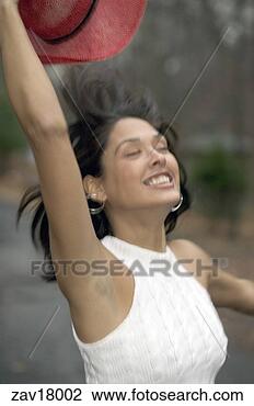 Stock Photo - woman taking off 
her hat. fotosearch 
- search stock 
photos, pictures, 
images, and photo 
clipart
