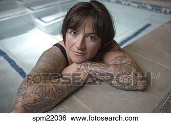 Stock Photo - woman with tattooed 
arms in hot tub. 
fotosearch - search 
stock photos, 
pictures, images, 
and photo clipart