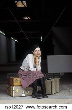 Picture - woman waiting 
with suitcases. 
fotosearch - search 
stock photos, 
pictures, images, 
and photo clipart