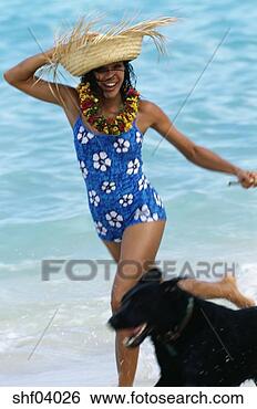 Stock Photo - woman wearing 
straw hat walking 
dog on the beach. 
fotosearch - search 
stock photos, 
pictures, images, 
and photo clipart