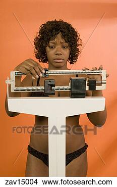 Stock Photo - woman weighing 
herself. fotosearch 
- search stock 
photos, pictures, 
images, and photo 
clipart