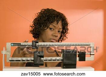 Stock Image - woman weighing 
herself. fotosearch 
- search stock 
photos, pictures, 
images, and photo 
clipart