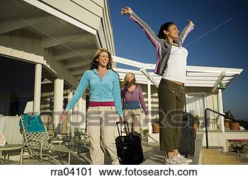 Stock Photography - women with suitcases 
arriving at vacation 
home. fotosearch 
- search stock 
photos, pictures, 
images, and photo 
clipart