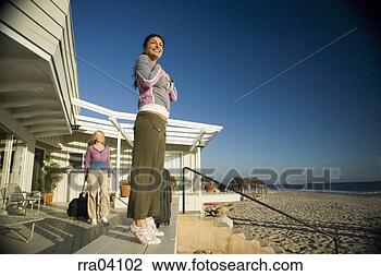 Stock Photo - women with suitcases 
arriving at vacation 
home. fotosearch 
- search stock 
photos, pictures, 
images, and photo 
clipart