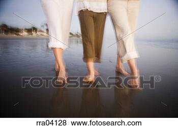 Stock Photo - women walking 
barefoot on beach. 
fotosearch - search 
stock photos, 
pictures, images, 
and photo clipart