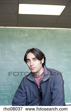 Picture - young adult man 
in front of chalkboard. 
fotosearch - search 
stock photos, 
pictures, images, 
and photo clipart