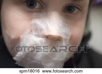 Stock Photo - young boy with 
face covered in 
tape. fotosearch 
- search stock 
photos, pictures, 
images, and photo 
clipart