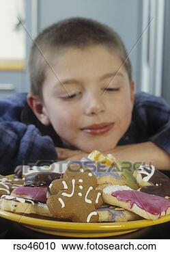 Stock Photography - young boy gazing 
at cookies. fotosearch 
- search stock 
photos, pictures, 
images, and photo 
clipart
