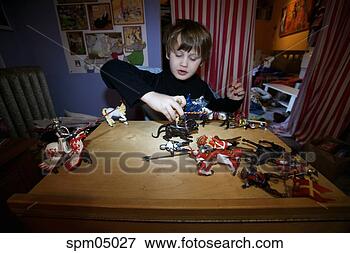 Picture - young boy playing 
with action figures. 
fotosearch - search 
stock photos, 
pictures, images, 
and photo clipart