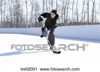 Stock Photography - young boy playing 
ice hockey. fotosearch 
- search stock 
photos, pictures, 
images, and photo 
clipart