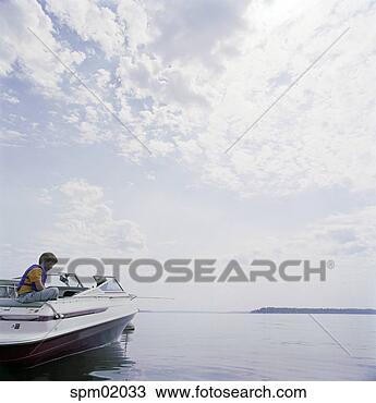 Stock Photo - young boy on speedboat 
in lake. fotosearch 
- search stock 
photos, pictures, 
images, and photo 
clipart