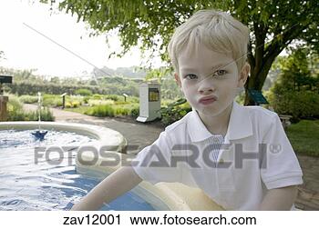 Stock Photography - young boy sticking 
hand in pool. 
fotosearch - search 
stock photos, 
pictures, images, 
and photo clipart