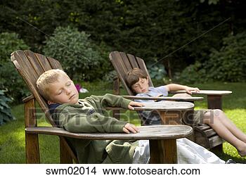 Stock Photo - young boys relaxing 
in backyard lawn 
chairs. fotosearch 
- search stock 
photos, pictures, 
images, and photo 
clipart
