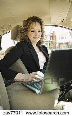 Stock Photography - young businesswoman 
with laptop in 
car. fotosearch 
- search stock 
photos, pictures, 
images, and photo 
clipart