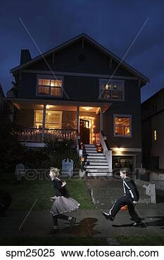 Stock Image - young children 
trick or treating 
on halloween. 
fotosearch - search 
stock photos, 
pictures, images, 
and photo clipart