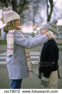 Stock Photo - young girl adjusting 
brother's knit 
hat. fotosearch 
- search stock 
photos, pictures, 
images, and photo 
clipart