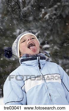 Stock Photography - young girl catching 
snowflakes on 
tongue. fotosearch 
- search stock 
photos, pictures, 
images, and photo 
clipart