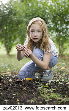 Stock Photo - young girl examining 
something in backyard. 
fotosearch - search 
stock photos, 
pictures, images, 
and photo clipart